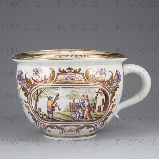 Chamber pot with genre miniatures, Porzellanmanufaktur du Paquier Vienna; 1718–1744. A chamber pot with a spherical, slightly elongated form, with a rolled-up, striped edge and a cylindrical handle. On the sides, two genre miniatures with ribald, erotic content, within gilded leafy Regency cartouches, complemented by purple Chinese latticework and a flower, a brick-red ribbon motif, and a brick-yellow volute, with two small miniatures in the frame reserves. The miniatures depict: 1 a field scene: two farmers and a woman trying to dissuade them from work by lifting her skirt; 2 a bagpiper playing for a couple dancing in a loving embrace, with rural buildings and a picket fence in the background. Between the miniatures is a bouquet tied with a gold ribbon; along the handle is an ornament with a gold campanula motif; the edge has a wide band of gilding and a volute ornament under the strip; gilding inside the chamber pot. 1725–1735. Vienna, Austria. Toilet bowl. Height 12.5 cm; width 21 c...