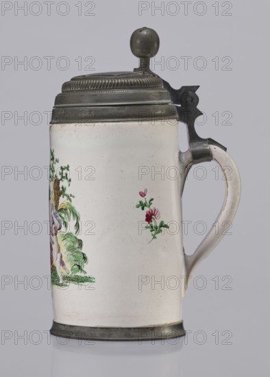 Cylindrical tankard in a pewter frame, Prószków Slaski faience factory; 1763–1853, miniatures, tankards, women. Cylindrical tankard in a pewter frame. White, painted in colors. From the front, a depiction of a barefoot woman sitting under a tree, her blouse unbuttoned, revealing her breasts. The woman, head turned to the right, supports with her right hand a small child, dressed in a short T-shirt, running towards her from the left. It can be interpreted as an allegorical representation of Maternitas motherhood. The representation is painted with some freedom. Late 18th century, Province of Silesia 1742–1918, Silesia, Prószków Slaski; vessel. Height 24.0 cm, width 15.0 cm, depth 10.5 cm., A ceramic tankard with a pewter lid and base, showing a smooth off-white body with hand-painted floral motifs in green, pink, and red and a partial painted scene with green foliage on one side, a curved handle with pewter mount and hinge, and a round pewter finial on the lid; colors visible include of...