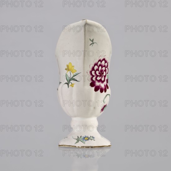 Nalewka, Prószków Slaski faience factory; 1763–1853, maker/manufacturer; floral decorations; locking; carnations flowers; repossession; Helmet-shaped Nalewka with locking and fluted surface. Bowl base and vaulted foot modeled with 4 leaves. T-shaped handle. Colorful decoration — bouquet with a large purple carnation with 3 buds and 3 small yellow flowers; small projections of flowers and leaves. Brown borders along the handle, edge of the bowl, and foot. Dated 1770–1783. Region: Province of Silesia, Silesia, Prószków Slaski. Vessel; height 19.0 cm, width 19.0 cm, depth 9.5 cm., A white ceramic vase with a scalloped elongated body and a rounded pedestal base, decorated with painted floral motifs in yellow, green, blue, and deep magenta, showing a large magenta flower on one side and smaller yellow and blue flowers with green leaves around the body and base, set against a neutral pale gray background.