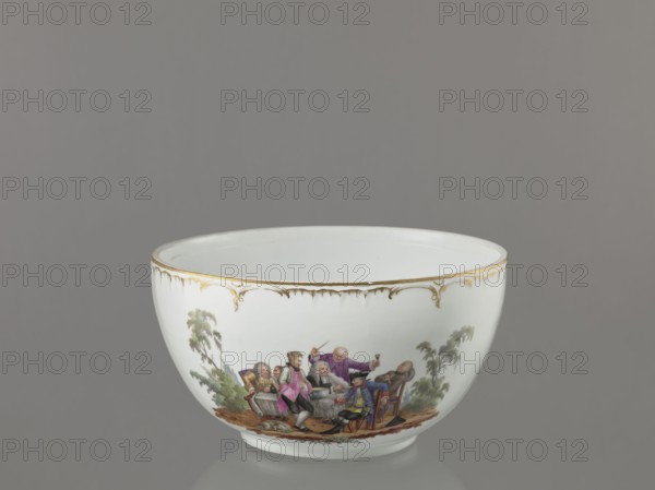 Punch vase with lid, KPM Königliche Porzellan-Manufaktur, Berlin, 1763–1918, reliefs, polychrome miniature paintings, hemispherical bowl with bottom rim and arched circular lid topped by a modeled half peeled lemon with stem, leaf, two slices and rolled-up peel. Rim of vase and lid with gilded relief rocaille decoration. Two color miniatures on lid park scenes: 1 three men in 18th-century costume seated at a table with a vase and glasses; 2 three men at a table with a vase, one standing. Two color miniatures on bowl park settings: 1 six people seated at a round table with glasses and pipes, one figure reclining before the table; 2 seven people seated at a table, singing, smoking pipes and conversing. Possibly after engravings by W. Hogarth. 4th quarter of the 18th century, Berlin, Germany. Vase; height 27.5 cm, width 28 cm., A white porcelain bowl with a gold-trimmed rim sits against a gray background, the exterior decorated with a painted scene showing a group of people in colorful cl...