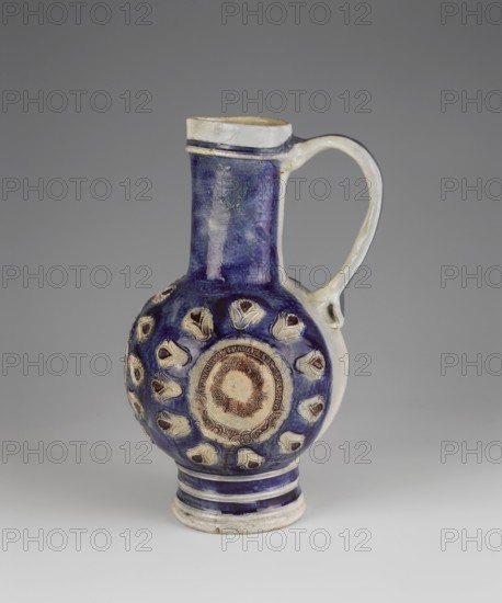 Jug, Westerwald ceramics center; ca. 1400–, stoneware jug with spherical body, high cylindrical neck and small triangular spout, wide almost cylindrical foot profiled with transverse rims and widened by a roller at the base. Prominent U-shaped applied handle. Glazed grey and cobalt blue with manganese accents. Relief decoration: three oval medallions within a wreath of radially arranged stylized lilies on the body. Central medallion: coat of arms with a crowned griffin; side medallions: busts of Louis XIV. Medallions are surrounded by a ribbon inscribed LUDOVICUS XIII.FRANCIAE.ET.N.REX.CHR.1679 and a laurel wreath. Below the medallions a symmetrical floral composition; French lilies and the letters PR appear at center on both sides. Belly background is sapphire except for a wide vertical stripe at the back, Louis's hair, the background of the ribbons and plant frames of the medallions, and the centers of the lilies, which are cherry-brown. Late 17th–18th century, Germany. Vessel. Heigh...
