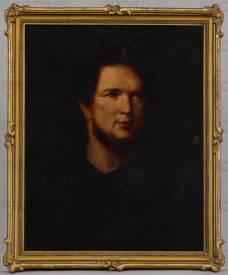 Portrait of Artur Stanislaw Potocki 1787–1832, Wojciech Korneli Stattler 1800–1875, painter, 1829, oil on canvas, height 64.5 cm, width 50 cm., A framed oil portrait of a person shown from the shoulders up, with a warm-toned face and dark hair; the background and clothing are very dark, creating strong contrast with the illuminated skin. The ornate frame is gold with carved decorative corners and edges. Visible colors include black, brown, warm beige or tan in the skin tones, dark brown in the hair, and gold in the frame.