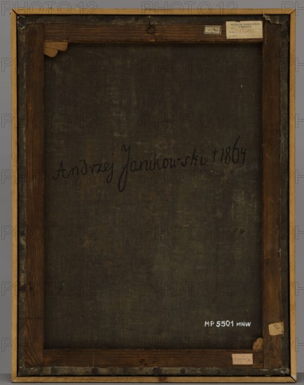 Portrait of Andrzej Janikowski, unknown Polish painter, ca. 1860, painting, height 82 cm, width 62.5 cm, A rectangular wooden frame with visible stretcher bars surrounds a dark, textured canvas showing uneven wear and subtle discoloration in shades of dark brown and olive. The inner wood has a warm brown tone with grain patterns and areas of darker staining, and the outer frame is a lighter tan wood. Small paper labels and remnants are attached at a few corners of the frame, appearing in beige and off-white tones. A small metal hanging ring is centered along the top inner edge of the frame. There are scuffed and worn edges where the canvas meets the frame, and a few spots on the canvas show faint lighter greenish-brown variations.