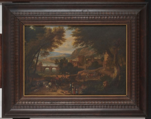 Landscape; Adriaen Fransz. Boudewijns 1644–1719, painter; 17th/18th century Flemish painting; subject includes buildings, bridges, horses, trees, carriages, rivers; medium: painting; dimensions: height 33.3 cm, width 47 cm., A framed landscape painting depicted within a wide dark brown wooden frame with carved ridges and a narrow inner gold trim; the painting shows a rural scene with a group of people and animals on a dirt path in the foreground, including several horses and a few figures gathered near the path, with trees framing both sides and large leafy canopies in green and brown tones; a stone bridge with arches spans a body of water toward the middle ground, beyond which a village of tan and ochre buildings and a tower cluster along the shore and at the base of rolling hills; distant hills and a sky with muted blues and warm golden clouds form the background, and overall the image contains colors including dark brown, green, tan, ochre, blue, gold, and touches of red.
