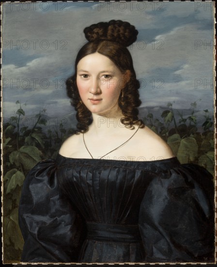 Portrait of a Young Woman, Ferdinand Georg Waldmüller 1793–1865, oil painting, female portrait, Austrian painting, German painting, dated 1830–1850; painting dimensions: height 69 cm, width 56 cm; with frame: height 80.5 cm, width 67 cm, thickness 7 cm; found in Jelenia Góra., A young woman with fair skin and dark brown hair styled with a rounded braided bun on top and long curled locks at the sides stands against a cloudy blue-gray sky and a background of green leafy plants; she wears a dark blue off-the-shoulder dress with a gathered bodice and voluminous sleeves, a thin dark necklace, and dangling gold earrings, and her face shows a neutral expression with rosy cheeks.