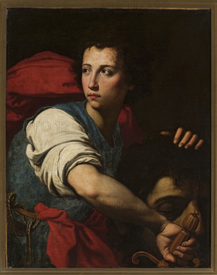 David with the Head of Goliath, Guarino Francesco 1611–1654, painter; painting, 17th century; subject: David and the head of Goliath biblical scene; dimensions: height 74 cm, width 58 cm., A young person with pale skin and dark curly hair looks to the side, wearing a blue garment and a white sleeve with the fabric folded, a red cloth draped behind and around them; their expression is neutral and their gaze is directed away from the viewer. A forearm extends across the image, showing the hand gripping a carved handle; another hand rests on a dark head with closed eye and dark hair partially visible. The background is very dark, creating strong contrasts with the illuminated skin tones and the vivid reds, blues, whites, browns, and black areas.