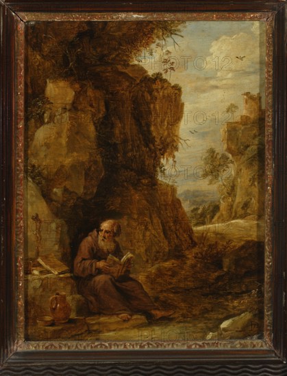 Hermit, Teniers, David II 1610-1690 painter, painting, hermits, Flemish painting, 17th century, height 24.2 cm, width 19.4 cm, The image shows a framed painting of a rocky landscape with a central cliff and a few trees; a lone seated figure in brown robes sits near the base of the rock reading a book, with a small jug and bowl on the ground nearby; the left side contains shadowed rock faces and vegetation, while the right side opens to a pale blue sky with clouds and distant cliffs and trees; colors visible include various browns, ochres, greens, pale blue, and touches of white and reddish tones in the frame.