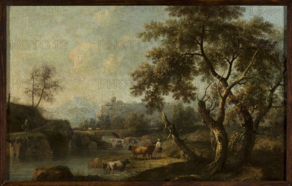 Mountainous landscape with cattle at a watering hole, Cimaroli, Giovanni Battista fl. ca. 1726–post 1753, painter; oil painting, 17th/18th century; landscape with cattle and staffage; height 29 cm, width 45.7 cm., A landscape painting showing a serene river scene with a group of large trees on the right, their trunks twisted and bark in shades of brown and dark gray with foliage in green and olive tones; a few branches extend across the sky. In the middle ground a small grassy bank in muted green and brown hosts a person standing beside two brown cows, while a light-colored cow stands at the water’s edge. A stone bridge arches over the river toward the left, beyond which distant wooded hills fade into soft blue-gray and green hues. The water reflects dark green and gray tones, and the sky above is pale with washed blues, grays, and hints of warm cream. The whole image is bordered by a dark wooden frame.