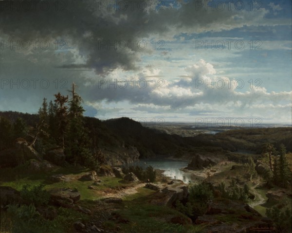 Landscape, Morten Müller 1828–1911, painter; Norwegian painting; 1854; oil on canvas; mountain landscape with lakes; height 101 cm, width 127 cm., A wide landscape view showing a rocky foreground with grassy patches and a winding dirt path leading toward a body of water surrounded by hills and cliffs; a group of tall trees and scattered smaller trees and bushes occupy the midground on the left and right, with exposed rock outcrops and ledges; the water reflects the sky and sits nestled among darker wooded hills that extend toward a distant, flatter horizon; the sky fills much of the scene with large dramatic clouds, including darker storm clouds and brighter billowing clouds, and areas of blue sky visible between them. Colors visible include green, brown, gray, blue, and white.