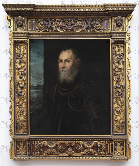 Portrait of a Venetian Admiral, Tintoretto, Jacopo 1519–1594, painter; Italian painting; portraits of men; landscapes; seascapes; Venetians; armor; Venetian painting; masterpiece; 2nd half of the 16th century, Venice; painting; height 81 cm, width 68 cm, A painted portrait of an older man with a gray beard and mustache wearing dark clothing with faint outlines of armor, set against a dark background with a narrow vertical strip of blue-green on one side, all contained within an ornate rectangular frame carved with floral scrollwork and small cherubic faces and finished in gold and dark brown tones.