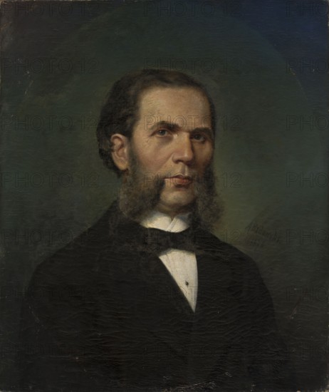 Portrait of Franciszek Ruskiewicz 1819–1880, painter; Badowski, Adam 1857–1903 author; tonda; portrait of artist; male portrait; bust, three-quarters; sideburns; 1876; painting; height 63 cm, width 53 cm, A painted portrait of a man shown from the chest up wearing a dark suit and a white shirt with a bow tie, with facial hair forming sideburns and a mustache, dark brown hair, and a neutral expression, set against a muted greenish-blue background with visible canvas texture and subtle darker and lighter areas; colors visible include dark black and brown in the clothing and hair, flesh tones in the face, white in the shirt, and green and blue in the background.