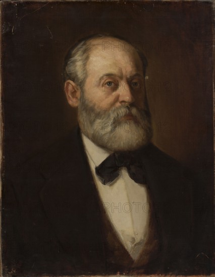 Portrait of Adam Malinowski, painter; Buchbinder, Szymon 1853–1922 author. Malinowski, Adam 1829–1892 — portrait; male bust, three-quarters; artist portrait. Depicts beard, mustache, gray hair, bald head, old age. 1877?; painting; 61 cm × 47.3 cm., A painted portrait of an older man shown from the chest up wearing a dark jacket, a white shirt, and a dark bow tie, with a full gray and white beard and mustache and short gray hair; his skin tones are light with subtle warm shading, and his eyes look slightly to the viewer’s left. The background is a deep brown with darker areas near the edges, and the overall palette includes shades of brown, black, gray, white, and muted flesh tones.