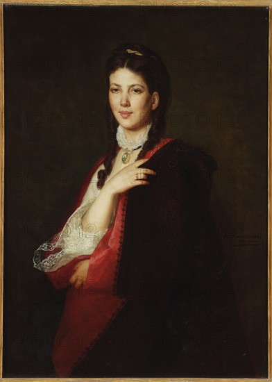 Portrait of Leonia Blühdorn, Rodakowski, Henryk 1823-1894 painter, lace, women's portraits, jewelry, portraits, Salon au Palais des Champs-Elysées Paris; 1872, Welt-Kunstausstellung Vienna; 1873, Blühdorn, Leonia 18..-1877 - iconography, 1870–1871, painting, height 100 cm, width 73.5 cm, A portrait of a young woman with pale skin and dark brown hair styled in braids and held with a small hair ornament, wearing a white lace collar and a decorative pendant at her throat; she has a calm facial expression and is shown from the waist up against a dark, muted background. She is draped in a deep red garment with visible lace-trimmed sleeves and a dark cloak layered over it, and one hand rests near her chest while the other is partially visible near her waist. The visible colors include dark brown, deep red, white, pale skin tones, gold in the pendant and hair ornament, and subtle greenish-brown in the background.