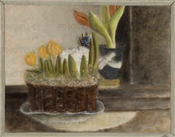Flowers; Jan Spychalski 1893–1946, painter; 1943; Poland; contemporary painting; oil on panel painting; 21 × 27 cm; provenance: purchase., A framed still-life showing a woven brown basket or container on a shallow white or pale dish, holding a group of yellow flowers with green leaves and stems and patches of white and green foliage; behind and to the right there is a dark blue or gray vase with larger green leaves and orange or reddish buds, set against a muted beige and dark brown background with a wooden or brown surface beneath.