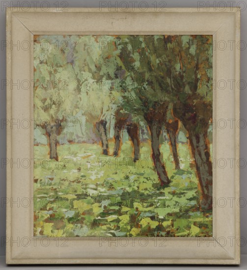 Bright Corner - Ornica; Jan Bohuszewicz 1878–1935, painter; contemporary painting; landscape; interwar period; Italy; 1926; painting; 39.5 × 35 cm, A framed painting showing a grove of trees with textured, impasto brushstrokes; the composition features a group of tree trunks in shades of brown and deep reddish-brown with leafy canopies rendered in various greens, olive, and touches of darker green, set against a misty background of pale green and muted sage. The ground is painted with layered patches of bright yellow-green, lime, and darker green tones with occasional brown and earthy accents, and there are small areas of pale blue and muted lavender scattered in the foliage. The frame around the painting is a worn beige or light tan with subtle discolored spots and a slightly darker inner edge, and the outer border of the image shows a surrounding neutral gray.