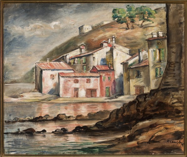 Southern Landscape, Kramsztyk, Roman 1885–1942, painter; contemporary painting, interwar period; Association of Polish Artists Rytm Warsaw; 1922–1932; landscapes; ca. 1930; France; painting; height 46 cm, width 55 cm, A painted coastal village scene showing a group of buildings of varied shapes and heights clustered at the water’s edge, with a few buildings painted in shades of pink and red, and others in beige, cream, and pale yellow with patches of green on shutters. The roofs are mostly reddish and brown, and the hillside behind the buildings is rendered in earthy browns and olive tones with a small group of green trees near the top. The foreground features a rocky shoreline in dark browns and blacks with reflections in the water that mirror pink, brown, and green hues, and the sky above is a mix of gray, blue, and muted beige with some cloud formations. The overall palette includes pink, red, beige, cream, yellow, green, brown, black, gray, and blue.