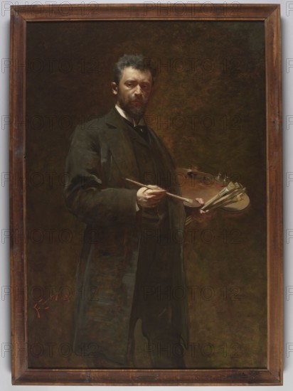 Self-portrait with a palette, Franciszek Zmurko 1859–1910 painter, 1895, painting, oil on canvas, height 160 cm, width 110.5 cm. Male self-portrait; artist depicted with palette and brushes; Young Poland style., A framed oil painting shows a man standing against a dark, mottled background of brown and olive tones, wearing a dark suit and long coat in deep black and brown shades; he has short dark hair and a beard with lighter highlights, and his face is lit to show a pale skin tone. He holds a wooden painter's palette with several smudges of paint in muted colors and a cluster of brushes while a brush is held in his other hand. The wooden frame around the painting is warm brown with visible grain and darker worn areas.