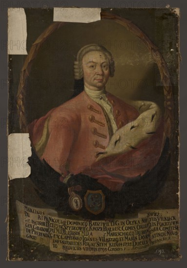Portrait of Marcin Mikolaj Radziwill 1705–1782. Oval portrait surrounded by a laurel wreath inscribed in the rectangle of the image. In the oval: half-length, turned slightly to the right, a slim man in a small powdered wig with a pigtail, a white shirt with a small jabot, a pale pink caftan with gold loops, and a red cloak lined with ermine fur draped around his shoulders. The background in the oval is gray-beige, smooth, brightened on the right. The portrait rests on the back of a black eagle with outstretched wings, a ducal mitre on his head and the Trumpets Traby coat of arms on his chest. In its beak the eagle holds the Przebendowski family's coat of arms a marten standing on its paws, holding a royal orb, and in its talons a white ribbon with a six-line Latin inscription. Background outside the oval is dark, brownish-gray, smooth. After 1737; painting; height 110.5 cm, width 74 cm. Artist: Józef Ksawery Heski ?–ca. 1810. Portrait with inscription; princely coats; wigs; jabots; er...