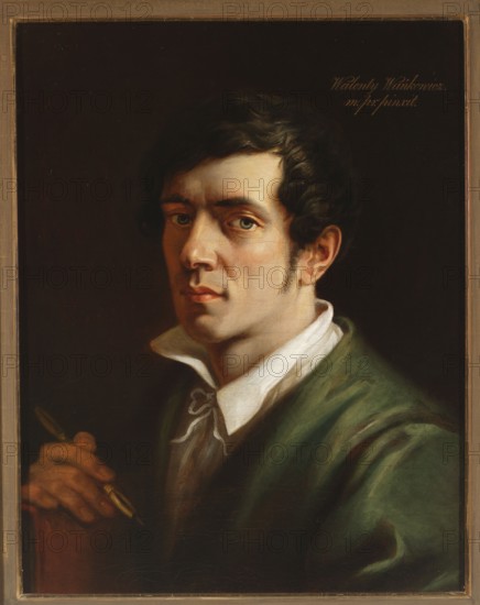 Self-portrait, Wankowicz, Walenty 1799-1842 painter. A young, dark-haired man with a slim face, short sideburns and hair combed sideways over his forehead towards the temples, wearing a green blouse and a white shirt with a slightly raised collar tied with a white drawstring, shown bust, turned three-quarters to the left, looking directly at the viewer. In front of him he holds a porte-crayon in his hand, resting on a small book with a red-brown cover. His oval face is illuminated from the darkness by a strong light coming from the right. Blue eyes, long, slightly upturned nose, clearly defined lips, chin slightly jutted forward. Black and brown background. At the top right, an inscription in white and yellow oil, calligraphic script: Walenty Wankowicz. | m. pr. pinxit. Before 1840, painting, 56.6 × 43 cm., A painted portrait of a man shown from the chest up against a dark background, with dark brown hair and light skin, neutral facial expression, greenish eyes, and sideburns; he wears...