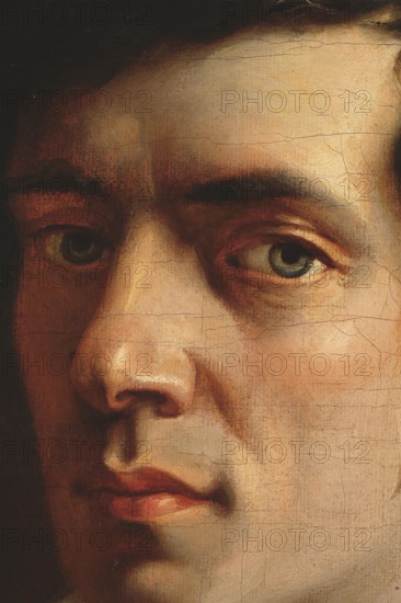 Self-portrait, Wankowicz, Walenty 1799–1842 painter. A young, dark-haired man with a slim face, short sideburns and hair combed sideways over his forehead towards the temples, wearing a green blouse and a white shirt with a slightly raised collar tied with a white drawstring, shown bust, turned three-quarters to the left, looking directly at the viewer. In front of him he holds a porte-crayon in his hand, resting on a small book with a red-brown cover. His oval face is illuminated from the darkness by a strong light coming from the right. Blue eyes, long, slightly upturned nose, clearly defined lips, chin slightly jutted forward. Black and brown background. At the top right, an inscription in white and yellow oil, calligraphic script: Walenty Wankowicz. | m. pr. pinxit. Before 1840, painting, height 56.6 cm, width 43 cm., A close-up of a painted human face showing an eye, part of the other eye, a nose, and mouth with visible brushstrokes and surface craquelure; skin tones range from pa...