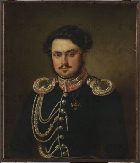 Portrait of Seweryn Madan, officer of the Guard Cavalry Staff, by Aleksander Kokular 1793–1846. Bust taken from the waist, turned slightly to the right. In the uniform of a second lieutenant adjutant of the Guard Cavalry Regiment: navy blue jacket with crimson collar, white inset at the clasp; epaulettes; buttons with eagle image; aiguillettes; silver Guards' stripes on the collar. On the left chest, a gold cross of the Virtuti Militari Order, class IV, awarded in 1831. November Uprising 1830–1831 context. ca. 1815–1830. Oil painting, 73 × 62 cm. Poland., A painted portrait of a man shown from the waist up wearing a dark uniform with ornate silver braided cords and large silver shoulder epaulettes, a decorative collar with red and silver elements, and a small decorative cross-shaped medal; he has dark wavy hair, a mustache and small beard, a neutral facial expression, and pale skin; the background is a muted brown-green, and the frame visible around the edges is dark brown.