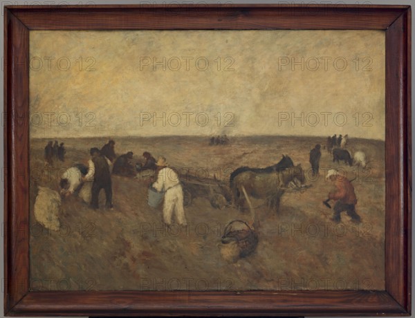 Digging Potatoes, unknown painter, origin unknown, early 20th century, painting, height 73 cm, width 100 cm, A muted landscape painting framed in dark brown wood shows a group of people and animals working in a field under a pale, cloudy sky. The scene includes a group of figures wearing garments in shades of white, brown, black, and muted red, some bending or carrying containers, and a few standing together in the distance. Several horses or mules in dark brown and black are positioned near a wooden cart, and a couple of baskets or containers in brown tones sit on the ground. The ground and surrounding terrain are rendered in earthy browns, olive greens, and muted ochre, while the sky is a washed blend of soft yellow, beige, and pale gray.