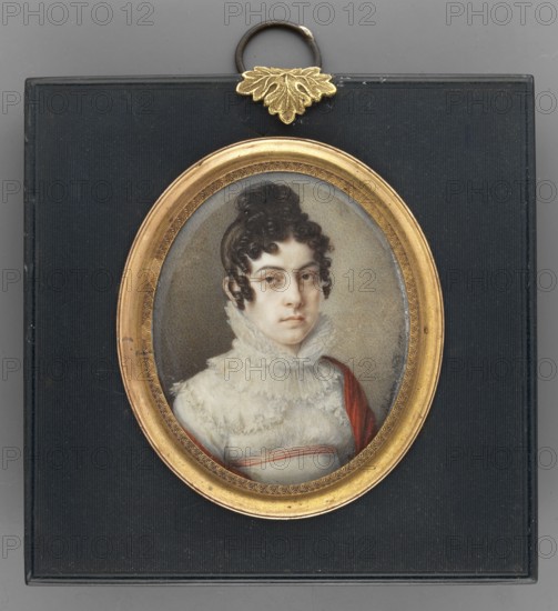 Fr. Anna Barbara Varwara Ivanovna with priest. Prozorowskich 1803–1828, wife of priest. Yuri Trubetsky, Nasti, Salvatore fl. 1816–1820 painter. Portraits 3/4 right of women Empire dress, shawls, dresses, hairstyles, empire style., repossession Jelenia Góra. Anna Ivanovna Troubetskaya 1803–1828. 1818. Italy. Miniature; height 6.6 cm, width 5.4 cm., A framed oval portrait of a person with pale skin and dark curly hair styled upward, wearing a high ruffled white collar and a garment with white and red elements; the portrait is set in a gold-toned ornate oval frame attached to a black rectangular backing with a small gold decorative leaf and a metal loop at the top; visible colors include black, gold, white, red, gray, and brown.