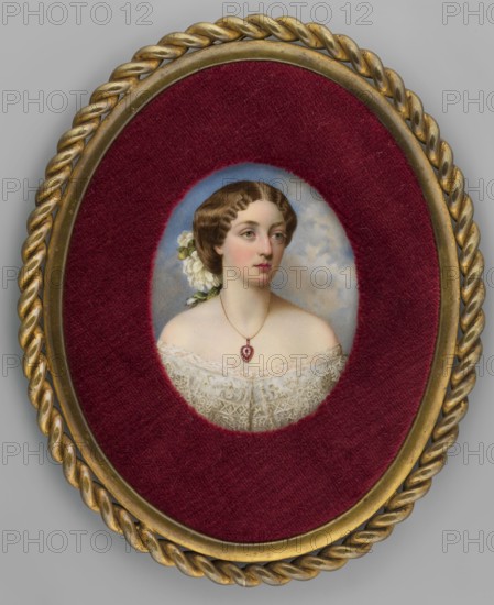 Marie Amalie von Baden 1834–1899, Duchess zu Leiningen. Portrait miniature by Eduardo Lobo de Moura 1817–1887, 1861, England. Bust, 3/4 right. Dark blonde hair gathered at the back à la Empress Eugénie, decorated with white flowers and green leaves; hazel eyes. Wearing a gold chain with a ruby and diamond heart; white dress with silver Berta lace. Background: blue sky with gray-white clouds. Miniature, 10.3 cm height × 8.2 cm width. Binding: secondary, brass rim in the form of a thick braid all around., An oval framed portrait shows a woman from the shoulders up set against a cloudy pale blue background, encircled by a deep burgundy velvet mat and a twisted gold outer frame; the woman has fair skin, brown wavy hair styled with white flowers at the back, soft pink cheeks and lips, and greenish eyes looking slightly to one side, wearing an off-white lace dress and a delicate necklace with a small pendant.