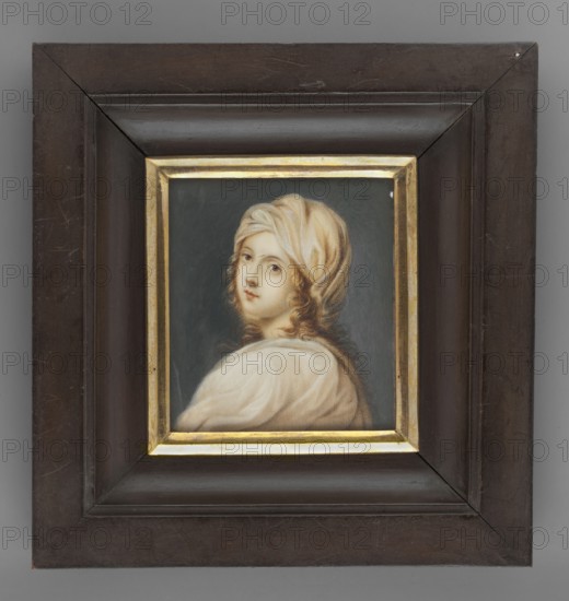 Beatrice Cenci, copy from Raphael; painter: Thil, Wilhelmine Louise du 1782–1819; subject: woman in a white robe and turban; miniature, height 7.7 cm, width 6.7 cm; date: 1820; notes: copy, foreign miniature; provenance/repossession noted., A framed portrait showing a person with light skin and light brown curly hair partly covered by a pale beige headwrap, turned slightly to the side and looking toward the viewer, wearing a soft white garment against a dark gray-green background; the portrait is set within a narrow gold inner frame and a wide dark brown outer frame with visible wood texture and scratches.