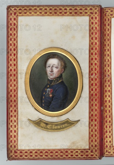 Portrait of the writer Heinrich Clauren 1771–1854, painted by Karl Gottlieb Heun 1771–1854 painter. Miniature portrait 1812, bust turned three-quarters to the left: dark blond hair, gray eyes, white shirt hem, black scarf, navy blue uniform with gold-embroidered collar, gold buttons, wearing three orders. Male portrait to the waist, torso left, head right; middle-aged man; soldier. Background olive-gray. Inscribed dimensions: height 6.3 cm, width 5.0 cm. Frame: gilded bronze., A framed oval portrait of a light-skinned man with short brown hair wearing a dark blue uniform with decorative collar and a few medals on his chest, set against a dark green background, mounted in a gold oval frame on a cream-colored panel that shows some brownish spots, all surrounded by a red border with intricate gold braided decoration and a gold crescent-shaped plaque beneath the portrait.