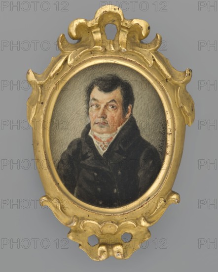 Portrait of a Man in a Black Frock Coat, Kokular, Aleksander 1793–1846, painter. Portrait of a man, half-length, three-quarters left. Short black hair; white cravat, white vest, black double-breasted frock coat; wearing the Order of St. Anne, 2nd Class. Background grey, lined. Oval wooden frame with Baroque ornament, plastered and gilded. Inscribed on front: A. Kokular. On back of frame: Pal. Kokular Alek. / Miniature: 'portrait of a man' / Polish painting / Catalog No. 20 / Miniature / Poland. Dated 1840. Miniature, height 6.3 cm, width 5.1 cm., An oval portrait of a man set in an ornate carved frame, the frame painted gold with scrolled and rounded decorative shapes and small areas of wear showing a darker base; the portrait shows a man with dark hair and sideburns wearing a dark coat and a light-colored high collar with a patterned cravat, his face rendered with flesh tones and subtle shading against a neutral gray background; visible colors include gold, black, dark brown, gray, be...