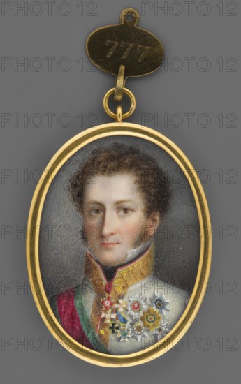 Prince Ernest I of Saxe-Coburg-Gotha 1784–1844 in a general's uniform of the Austrian army, formerly attributed Prince of Schwarzenberg; miniature 1814–1815, height 4.6 cm, width 3.3 cm. Shoulder-length, 3/4 left, almost en face; curly brown hair, brown eyes, white shirt collar, black neck scarf. White Austrian army uniform with collar and fastening trimmed in gold braid. Around the neck: red cross on a red ribbon of the Russian Order of St. Alexander Nevsky; below it the Prussian Order of the Red Eagle. On the chest: Russian Order of St. George, 4th Class; Saxon Order of St. Henry; Austrian Cannon Cross; and five stars of the Austrian Hungarian Order of St. Stephen, Russian Order of St. Andrew, Saxon Order of St. Henry, Saxon Order of the Rue Crown, and Prussian Order of the Black Eagle. Right shoulder bears the red ribbon with green edges and star of the Order of St. Stephen. Background gray-brown. Binding: gilded bronze, narrow rim. Handwritten German inscription on the reverse read...