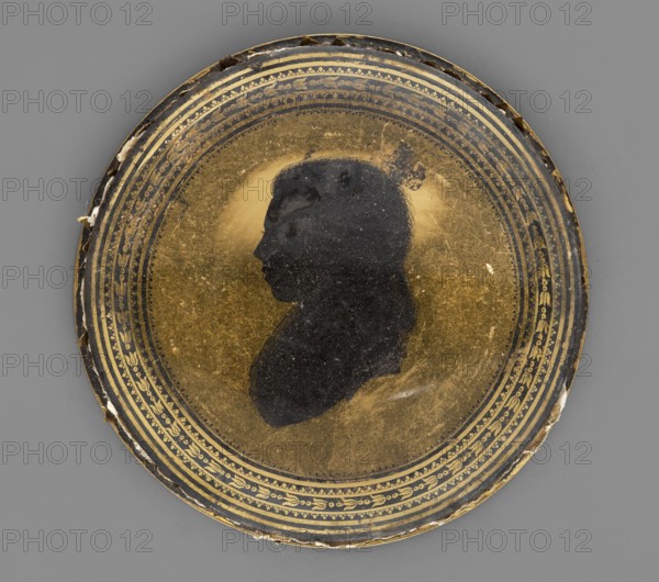 Profile of a Girl. Unknown author; amateur painter. Left profile of a young girl—black silhouette on a gold background with black and gold ornaments around; ornaments and profile scratched out. Medium: black ink on paper; miniature. Date: 1795. Height: 7.2 cm., A round decorative object with a central dark silhouette of a person's profile against a metallic gold background, surrounded by concentric patterned bands with ornamental designs; the outer edge shows areas of wear and chipped material. Colors visible include gold, black, and shades of gray.