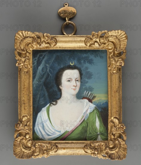 Caroline Louise of Hessen-Darmstadt as Diana 1723–1783, Margravine of Baden; unknown painter; miniature portrait, ca. 1750; watercolour on ivory height 7.8 cm, width 6.5 cm. Inscription/labels: No. 5 | Caroline Luize | Gemahlin des Markgrafen | Carl Friedrich von Baden | Tochter Ludwigs, born 11 July 1723 + 8 April 1783. Called by her contemporaries the Hessian Minerva hessische Minerva. Subjects/themes: antiquity, women, portraits, costumes, female portraits, rulers, amateurs. Repossession provenance: Jelenia Góra., A small rectangular painted portrait set in an ornate gold frame with carved shell and floral motifs around the corners and edges, the frame suspended by a metal loop at the top; the painting shows a fair-skinned woman with dark curled hair and a small crescent-shaped ornament above her forehead, wearing a low white chemise with ruffled trim and a green garment with a diagonal pink sash, a quiver with visible feathers resting behind her shoulder, and a background of dark t...