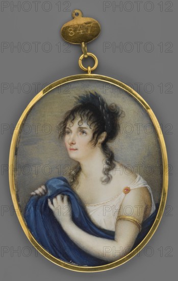 Ascenbraun, Hessian theatre artist, unknown role, painter; portrait of a woman in antique costume à l'antique; hairstyle and theatrical costume details; miniature height 7.5 cm, width 5.8 cm; dated 1830; Germany., An oval pendant with a gold frame against a gray background shows a painted portrait of a woman from the shoulders up; she has pale skin, dark curly hair pulled back with a dark blue or black headpiece, and a few loose curls around her face, and she looks upward and slightly to the side with a calm expression; she wears a white, off-shoulder dress with a decorative clasp on one strap and a gold armband on her upper arm, and she holds a draped deep blue cloth in her hands; the pendant includes a gold loop and small oval attachment above it.