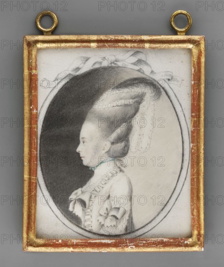 Magdalena Sophie von Anhalt-Bernburg-Schaumburg-Hoym née Prinzessin zu Solms-Braunfels 1742–1819, unknown amateur painter; portrait miniature, c. 1800; height 11.8 cm, width 9.5 cm. Inscription on the back: Magdalene Sophie / Prinzessin zu Anhalt-Bern../ burg-Schaumburg geboren / Prinzessin zu Solms-Braun / fels stab als Wittwe / und des Kaiserl. Russischen/St. Katherinen Ordens Gross Kreuz Dame.” A piece of paper and a sticker glued to the backing: “Magdalene Sophie / Prinzessin zu Anhalt-Bern../ burg-Schaumburg geboren / Prinzessin von Solms-Braunfels / geboren de 4ten Januar 1742 / gestorben den 21ten Januar 1819.” On a sticker, fragment of a seal reading …aa:…mars…i – p. 116. Subject: aristocracy; female portrait in profile; headgear, hairstyle, and dress depicted; foreign miniature style., A framed oval portrait showing a left-facing woman with an elaborate high coiffure rendered in soft grayscale, wearing a light-colored dress with ruffles and bows and a narrow colored ribbon at ...