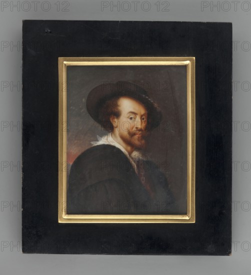 Portrait of a Man in a Hat, copy from Rubens' self-portrait; Wilhelmine Louise du Thil 1782–1819, painter amateur. 1816. Miniature, 8.0 cm × 6.5 cm. Subject: male portrait wearing a hat; costumes; style: copy of Rubens; genre: foreign miniature., A framed portrait of a man wearing a wide-brimmed hat and dark clothing is centered within a rectangular black frame with a narrow gold inner border; the man has light skin, reddish-brown hair and beard, and a white ruffled collar, and his expression appears calm as he looks slightly toward the viewer against a dark, muted background with hints of brown and red.