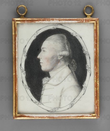 Ludwig Rudolf Wilhelm Prince Solms Braunfels 1733–1803, unknown author painter / amateur painter. Aristocracy; male portrait in profile; foreign miniature; Hessian/Rhine region; Ernst Ludwig Grand Duke; 1868–1937, Repossession noted Jelenia Góra. Visual documentation ca. 1800. Miniature, height 11.5 cm, width 9.7 cm., A framed portrait of a person shown in profile facing left, rendered in black and white with subtle flesh tones on the face; the subject has powdered or light-colored hair styled back and tied with a ribbon, and wears a high-collared garment with a lace detail at the throat. The portrait is set within an oval dark background and bordered by a simple decorative oval line, all enclosed in a rectangular frame with worn gold and brown edges and two circular hanging loops at the top. The surrounding area outside the frame is a smooth gray.