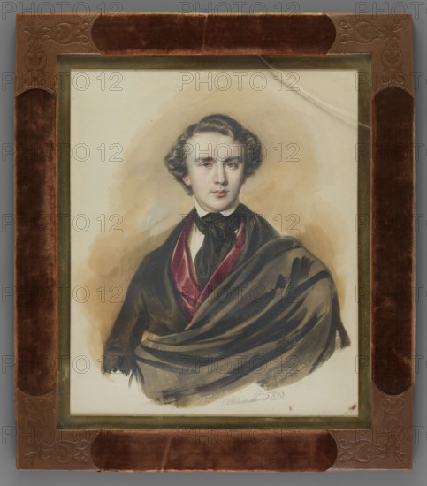 Alfred Józef Potocki 1822–1869, son of Alfred Wojciech and Józefa née Czartoryska, 2nd Entailer of Lancut. Painter: Jan Nepomucen Glowacki 1802–1847. Half-length portrait, head almost straight. Short hair, white shirt and collar, black cravat, burgundy waistcoat, dark brown frock coat and cloak-cape à la Byron. Background: light ocher with a light blue spot. Binding: gilded bronze, velvet, embossed leather. Date: 1843. Place of origin: Poland. Miniature; height 25.2 cm, width 20.8 cm., A framed portrait of a young man shown from the waist up, with wavy dark brown hair and a pale complexion, wearing dark clothing including a black bow at the neck and a draped dark cloak with a deep red inner lining; the background behind him is a soft beige wash. The portrait is set within a narrow gold-colored inner frame and a wider outer frame covered in brown velvet and embossed brown leather at the corners. The visible colors include brown, beige, black, dark red, gold, and pale skin tones.