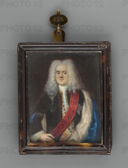 Frederick William I of Prussia? 1688–1740, unknown artist, amateur painter. Portrait, waist-length, left; men's portrait waist-length, left. Subject: middle-aged man wearing a long white wig with curls parted in the middle; sapphire coat lined with white fur, white embroidered vest, white shirt; silver star of an order on a red ribbon. Style: foreign miniature, half-length, almost straight pose. Background: brown. Inscription/marks: orders. Provenance note: repossession Jelenia Góra. Object: miniature, tortoiseshell binding rim profiled, narrow, dated circa 1770. Dimensions: height 7.8 cm, width 6.3 cm., A framed portrait of a person with pale skin and a large powdered wig, wearing dark clothing with a red sash draped across the chest and a light-colored fur or fabric over one shoulder; the figure's hands are visible at the lower edge of the portrait. The rectangular frame is dark brown with some worn areas and small scratches, and a metallic hanger with a small oval plate is attached ...