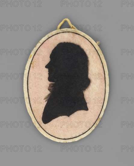 General Stanislaw Mokronowski 1761–1821, son of Ludwik and Józefa née Czosnowska, profile silhouette miniature portrait, Krzeszowice Lesser Poland Voivodeship, aristocracy, male general, profile portrait, Polish miniature, amateur maker, military subject, dated 1780, Poland; miniature; height 4.2 cm, width 3.4 cm., An oval pendant with a thin rope loop at the top shows a dark silhouette of a person's profile against a pale pink background, surrounded by a creamy off-white border with a thin dark inner line; colors visible include black, pale pink, creamy off-white, golden yellow for the rope, and gray in the surrounding area.
