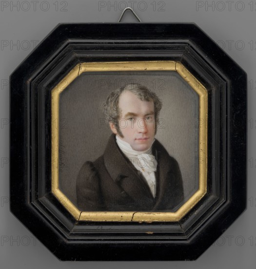 Portrait of Pastor Krauss, court chaplain of the Counts zu Erbach-Erbach, by Johannes Gauff 1804–1858. Miniature portrait, 1840–1850, Germany. Shoulder-length men's portrait 3/4 right showing clergy pastor dressed in a brown-gray tailcoat, white shirt, cravat and waistcoat; gray-gray hair, sideburns, gray eyes. Sandy-gray background. Bust view. Black varnished wood binding with gilded rim inside. Height 7.5 cm, width 7.5 cm., A framed portrait of a man shown from the chest up wearing a dark brown coat and a white cravat, with light skin and short wavy grayish-brown hair and sideburns, set against a neutral gray background; the portrait is enclosed in an octagonal inner frame with a gold-colored border and an outer black frame that has a glossy finish and a small metal hanger visible at the top; visible colors include brown, white, gray, gold, black, and subtle flesh tones.