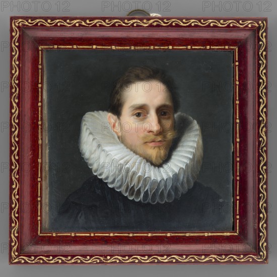 Portrait of a Man, copy from a portrait by Van Dyck. Copy by Stanislaw Marszalkiewicz 1789–1872. Young man, 3/4 bust right; short brown hair, light blond facial hair, mustache and Spanish goatee; wide tubular white ruff at the neck; black clothing. Background dark grey. Miniature, height 7.4 cm, width 7.8 cm. Rectangular wooden frame made of slightly recessed mahogany strip with embossed and gilded ornaments S. Malicki company, ul. Nowosenatorska 7. Inscription: S. Marszalkiewicz June 25, 1918. Copy from a portrait by Van Dyck / detail / from the Dresden Gallery., A framed portrait of a man with light skin and brown hair, shown from the shoulders up, wearing a large white pleated ruff collar and a dark garment, set against a dark gray background; the man's expression is neutral with a slight closed-mouth smile and a short brown beard and mustache. The frame is ornate and wooden with a dark red finish and gold decorative trim along the inner and outer edges. The visible colors include w...