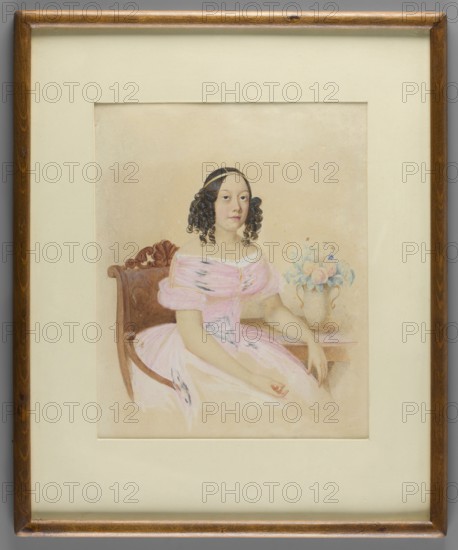 Portrait of a Young Woman in a Light Pink Crinoline, attributed to Stanislaw Marszalkiewicz 1789–1872. Miniature, height 21.2 cm, width 17.3 cm. Three-quarter seated portrait of a young woman facing right: dark brown hair parted into three sections with an angled side style and a gold band above the forehead. She wears a pink crinoline dress with a white lace ruffle at the neckline. Right hand rests on her lap; left rests on a round table holding a yellowish vase with flowers with bluish leaves. Light brown armchair and a similar table with pink reflections; paper-colored background. Binding: secondary, narrow wooden strip. Attributed based on tradition and stylistic analysis., flowers, bouquets, women, portraits en three-quarters, portraits of women, roses, Polish miniatures, interiors, dresses. Date: 1840; place of origin: Poland., A framed watercolor portrait shows a seated woman with dark curly hair held by a hairband, wearing a pale pink off-the-shoulder dress with delicate folds ...