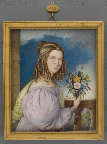 Portrait of a Girl with a Bouquet, unknown artist, portraits waist-length, left, woman holding flowers bouquet, landscape visible through a window background, dress with puffed sleeves leg-of-mutton style, foreign miniature, amateur, 1840, miniature, height 13.0 cm, width 10.7 cm, A framed painted portrait of a young woman shown from the waist up, wearing a pale pink dress with voluminous sleeves and a light green shawl draped over one shoulder; she has pale skin, blue eyes, and brown hair styled with a braided bun at the back and long ringlets at the sides, with a thin headband across her forehead. She holds a bouquet of mixed flowers in one hand, featuring visible colors of yellow, pink, blue, white, and purple, with green leaves. The background shows a blue sky with cloud-like shapes and a stone balustrade or ledge beside her, with a tan or beige column at the left edge. The painting is set in a gold frame against a gray background, and a small gold hanging plaque is attached at the...