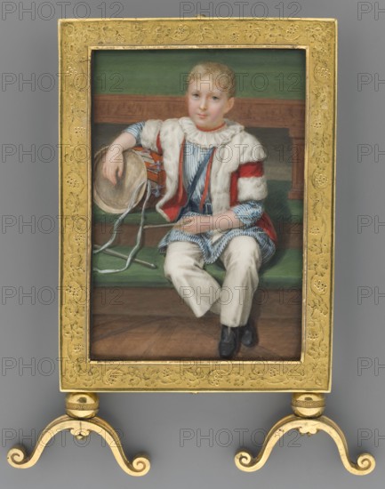 Adam Potocki from Krzeszowice at the age of 5 1822–1872, painted by Józef Sonntag 1784–1834. Subject: boy in aristocratic costume, standing en pied in an interior, with toys and musical instruments. Style: Biedermeier miniature, painted 1827. Medium/size: miniature, height 12.3 cm, width 8.0 cm., A framed portrait of a young person seated on a bench, wearing a striped garment with a ruffled collar and a fur-trimmed cape, holding a drum beside them; the figure has light hair and a neutral expression. The scene includes a wooden bench and floor and a backdrop with horizontal bands. Visible colors include gold from the ornate frame, green in the bench and backdrop, red accents on the cape, blue and white stripes on the clothing, cream or beige in the fur trim and pants, brown wood tones, and black shoes.