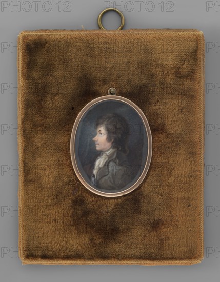 Tadeusz Kosciuszko in his youth in a grey frock coat, Rustem, Jan 1762–1835 painter, men, male portraits, soldiers, profiles portraits, Polish miniatures, commanders, Kosciuszko, Tadeusz 1746–1817, Kosciuszko Uprising 1794. In civilian costume. Bust in left profile, short dark hair, white shirt collar and jabot, grey frock coat, black belt with a silver buckle. Background: grey-blue, lightened around the head. Frame: narrow oval copper frame in a plush contemporary passe-partout. Jan Rustem is the author of many images of the Chief, which were very popular. 1794, Vilnius, miniature, height 4.8 cm, width 3.8 cm, A small oval portrait of a person in profile set in a metal frame rests on a rectangular brown velvet pad with a metal hanging loop at the top; the portrait shows a person with dark brown hair wearing a light-colored neckcloth and a darker coat against a bluish-gray background, and the surrounding pad displays shades of brown and tan with slightly darker mottled areas.