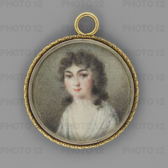 Pelagia Róza née Potocka 1775–1846, famous for her beauty, wife of Pawel Sapieha. Painter: Wincenty de Lesseur 1745–1813 — possibly by Lesseur or unknown painter. Painted in Lesseur's district, Krzeszowice Lesser Poland Voivodeship. Subject: three-quarter female portrait/miniature. Date: 1780. Medium: miniature. Height: 4 cm., A circular pendant with a decorative gold rim and a loop at the top contains a painted miniature portrait of a young person with curly dark brown hair and fair skin, shown from the shoulders up and wearing a light-colored garment. The face displays subtle pink tones on the cheeks and lips, dark eyebrows, and brown eyes. The background inside the pendant is a muted gray-green, and the outer background behind the pendant is a smooth medium gray. The visible colors include gold, dark brown, fair peach, pink, white, light blue-gray, and medium gray.