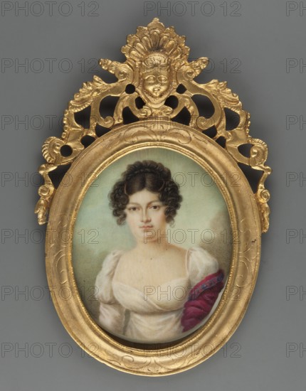 Portrait of a woman with a typhtic shawl and a white dress, unknown artist, women, women's portraits, dresses, three-quarter portrait, Polish miniature, 1820, miniature, height 6.0 cm, width 5.0 cm, An oval portrait of a woman set in an ornate gilded frame with carved decorative flourishes and a small sculpted face at the top; the woman has dark curly hair styled close to her head and a neutral facial expression, wearing a white, low-cut dress with puffed sleeves and a draped reddish-purple shawl on one shoulder; the painted background is a soft muted green and the frame and surrounding decorative elements are gold against a plain gray surface.