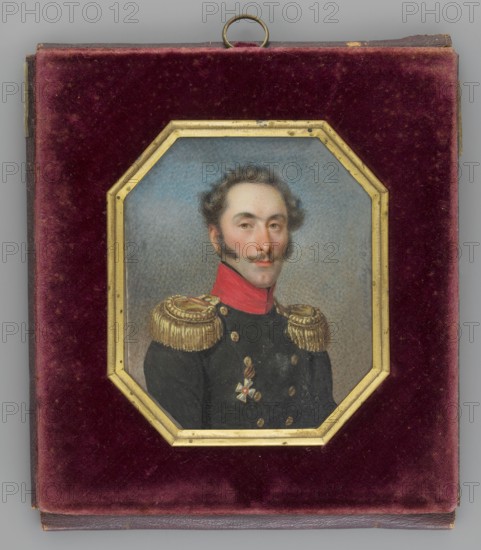 Portrait of Jan Witt Ivan Osipovich de Witt 1781–1840, Russian cavalry general. Painted by Józef Sonntag 1784–1834. Bust three-quarter right; dark blond hair, mustache, sideburns. He wears a navy blue staff officer’s uniform with gold epaulettes, red collar, and black scarf; the Order of St. George is shown on the left. Background: blue sky above, clouds below. Octagonal frame of gilded gilded bronze in a leather case lined with cherry-red velvet. Inscription/date: 1832, Poland. Miniature, height 7.0 cm, width 6.0 cm., A small framed portrait set into a square case with a plush velvet interior in deep burgundy surrounds an octagonal gilded frame; inside the frame is a painted bust of a man with pale skin and dark wavy hair and sideburns, a slight mustache, and a neutral expression, shown against a muted blue-gray background. He wears a dark uniform with a high red collar, ornate gold fringed epaulettes, gold buttons, and a decorative medal with gold and white elements on his chest. The...
